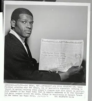 Bob Gibson Holding Newspaper