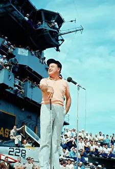 United Service Organizations Prints: Bob Hope Performing for Troops Near Microphone