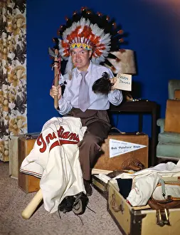 Bob Hope Wearing Native Headdress with Suitcases