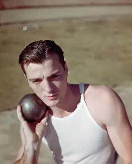 Decathlon Prints: Bob Mathias Holding Shot Put Under Chin