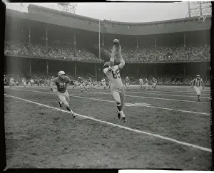Bob Schnelker Reaching for Football Catch During Game
