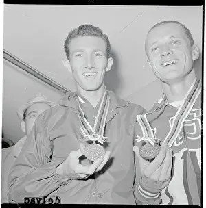 Bob Schul and Bill Dellinger Posing with Their Medals