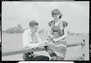 Bob Sulat and Mary Ellen Holding Flowers