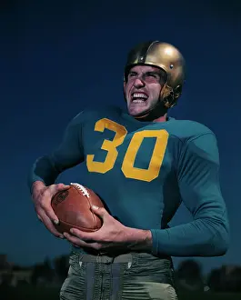 Bob Wilkinson of UCLA Holding Football