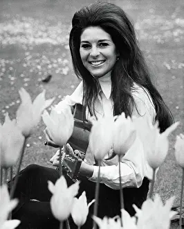 Bobbie Gentry Seated and Playing Guitar