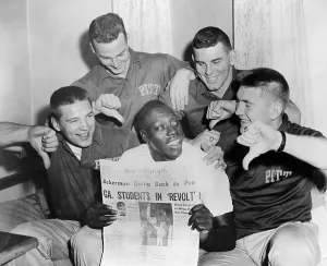Desegregation Prints: Bobby Grier Holding Newspaper on His Team's Protests