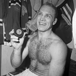 Bobby Hull in Locker Room With Hockey Puck