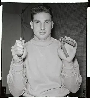 Bobby Thomson Holding Exercising Apparatuses