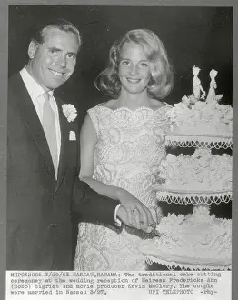 Bobo Sigrist and Her Groom Cutting Wedding Cake