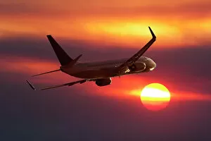 Images Dated 13th July 2018: A Boeing 737 airliner flying into a sunset