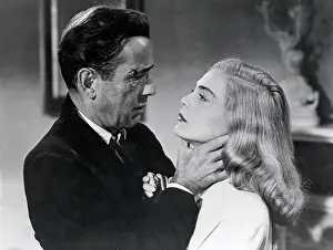 Prints of (Original Caption) 03/18/1949. TAKING THE BOGIE OUT OF BOGART. (third of five). Looking slightly less than gentlemanly, Bogart again seems to find a neck-hold fascinating The Essence of Cool: Bogart In 'Dead Reckoning' Movie