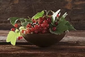 Pastoral Gallery: A bowl with red currants (Ribes rubrum) on a wooden background