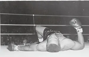 Boxer Archie Moore Lying on Canvas