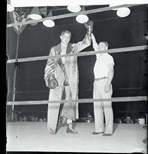 Boxer Buddy Baer Being Coaxed Into Victorious Pose