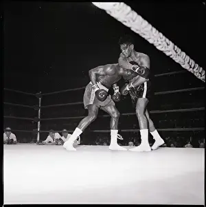 Boxer Held Under Arm Of Bloody Opponent