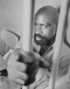 Prison Bars Prints: Former Boxer Rubin Carter Gripping Jail Bars