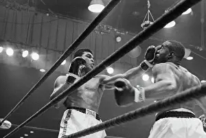 Prints of Boxer Cassius Clay punches boxer Sonny Liston in the sixth round during their fight in 1964 A photo tribute to the boxing legend: Boxers Clay and Liston Fighting