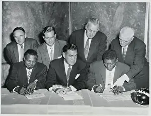 Contract Prints: Boxers Moore and Patterson Signing Contracts