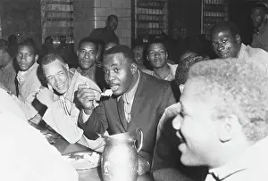 Boxing Champion Sonny Liston Sharing a Meal with Prison Inmates