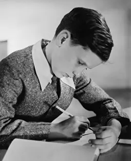 10 11 Years Prints: Boy (10-11) writing in notebook (B&W)