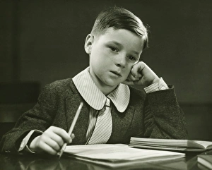 Support Collection: Boy (8-9) doing homework, (B&W), portrait