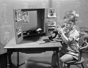 Hobbies Prints: Boy (8-9) playing with microscope