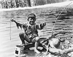 String Prints: Boy Displays String Of Caught Fish