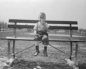Boy Eating Ice Cream Cone Alone on Bench