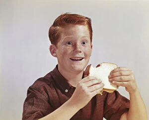 Casual Collection: Boy eating sandwich, smiling