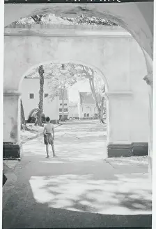 Desolate Prints: Boy Gazing out from Underneath Archway