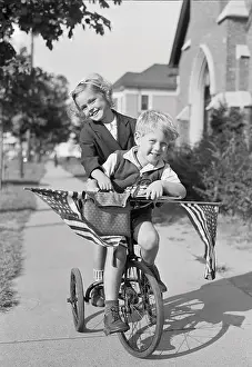 Baby Girl Prints: Boy and girl (8-9 years) riding bicycle