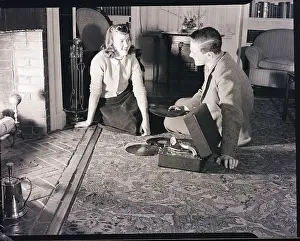 Boy and Girl Sitting by Fireplace with Phonograph