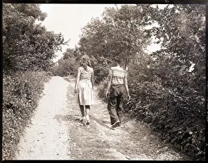 Boy and Girl Walking on Country Road