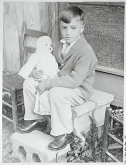Boy Holding a Doll