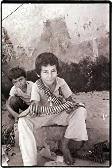 Bullet Prints: Boy Holding Used Cartridge String