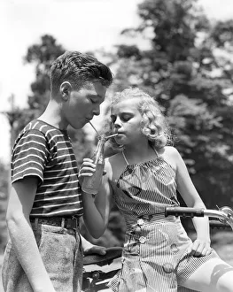 Boy In Horozonial Stripe Shirt & Girl Wearing A Ve