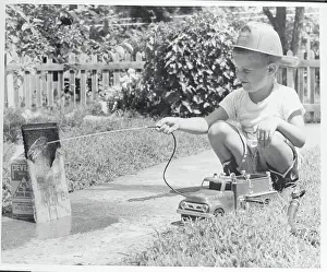 Optimism Prints: Boy Hosing His Makeshift Toy as a Fireman