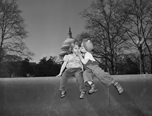 Boy Kissing Girl On Wall;Capital In Back