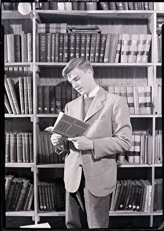 Library Prints: Boy in Library Reading Book