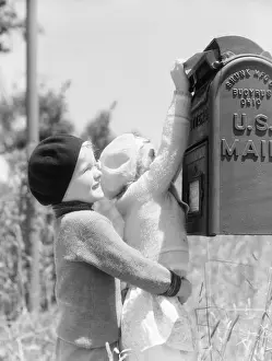 Brother Prints: Boy lifting up girl to reach U. S. mail box, helping her mail letter