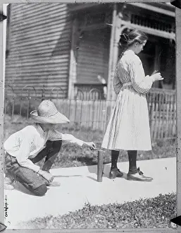 Caution Prints: Boy Lighting Firecracker Behind Girl