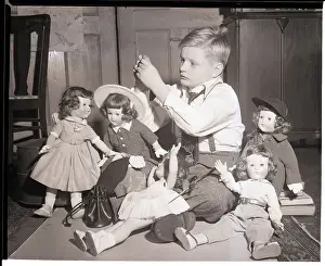Auction Prints: Boy Playing with Designer Dressed Dolls