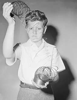 Civil Prints: Boy Playing With Slinky Toy