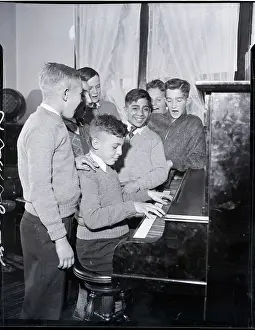 Boy Plays Piano Boys Sing Around Him