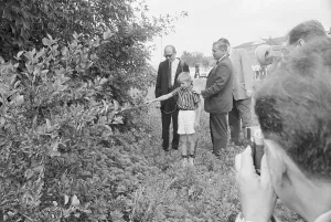 Displaying Prints: Boy Pointing To Spot Behind Bush