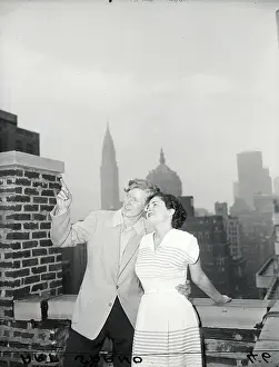 Displaying Prints: Boy Showing Girl Sights Atop Hotel
