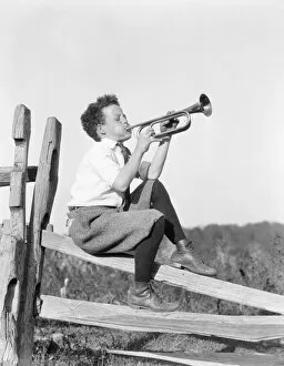 Boys Gallery: Boy sitting on fence, playing musical instrument