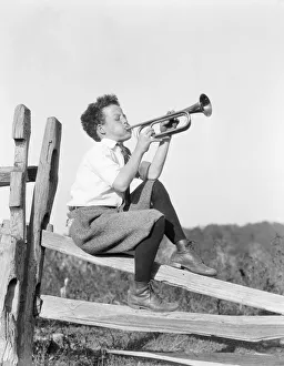 Boys Gallery: Boy sitting on fence, playing musical instrument