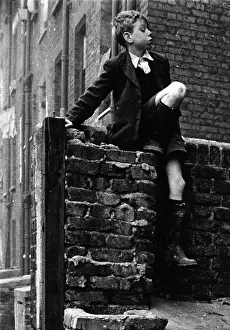 Boy Sitting On Wall