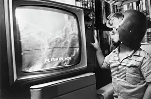 Enchantment Prints: Boy with Space Helmet Watching Moon on Television
